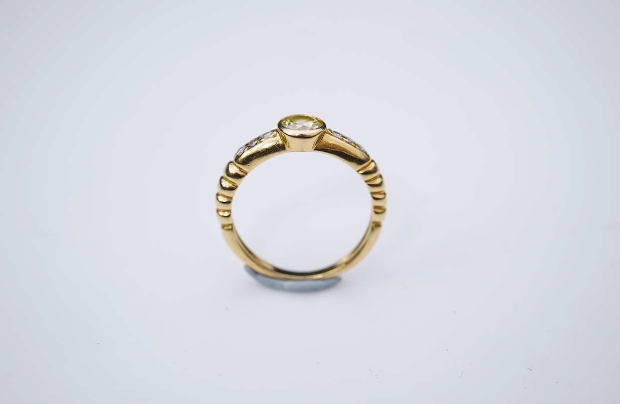 A yellow diamond and diamond ring